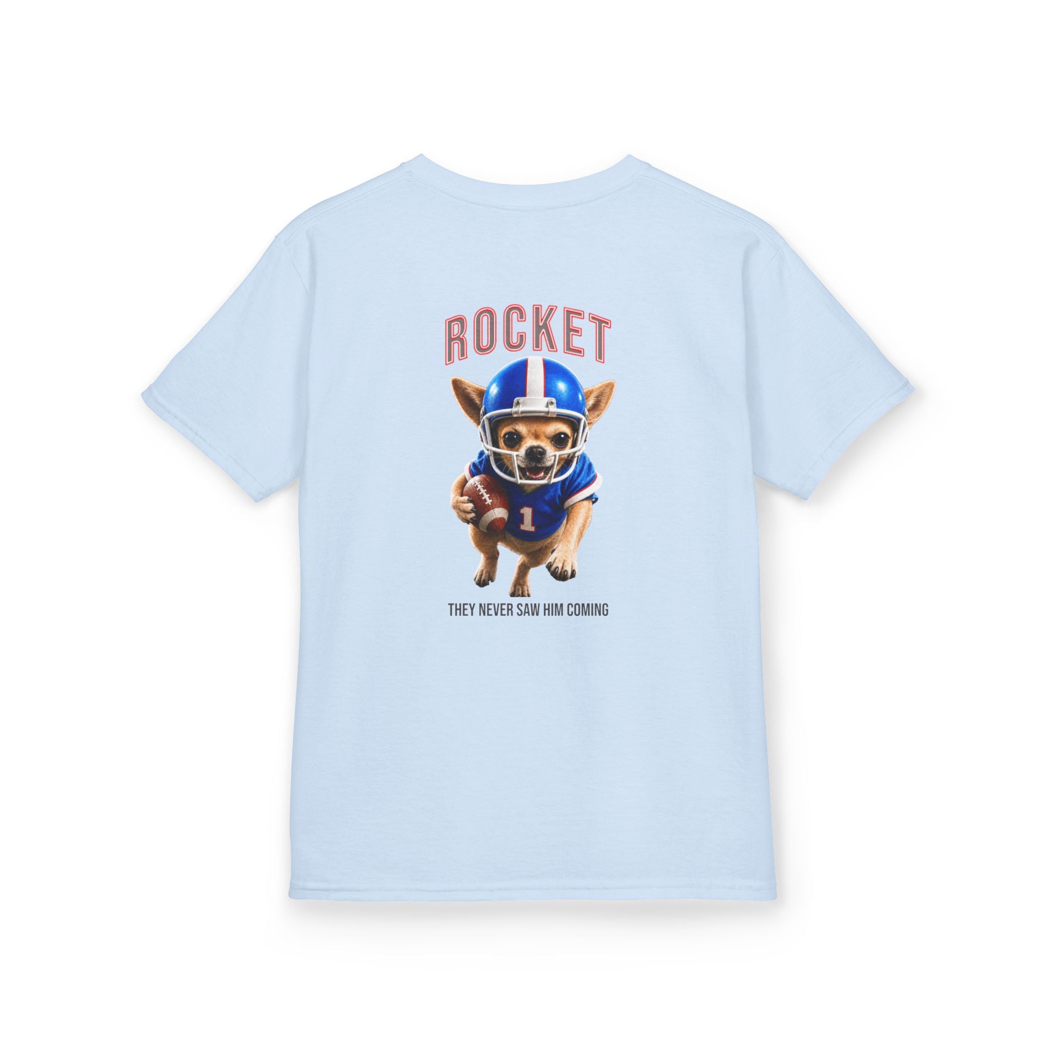 Light blue youth graphic t-shirt featuring Rocket™ the Chihuahua dressed in a blue football uniform and helmet, carrying a football with “They Never Saw Him Coming” text and Recess Riot mascot artwork on the back.